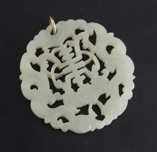 A Chinese pale celadon and jade circular plaque, 19th century, diameter 5.4cm